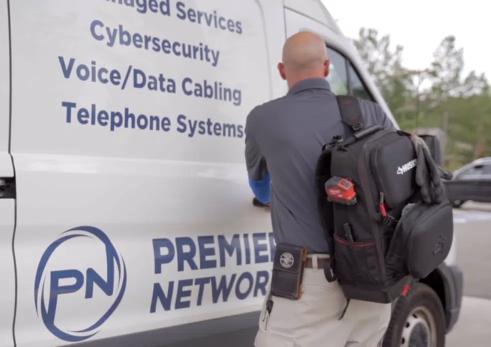 infrastructure cabling technician getting into Premier Networx van